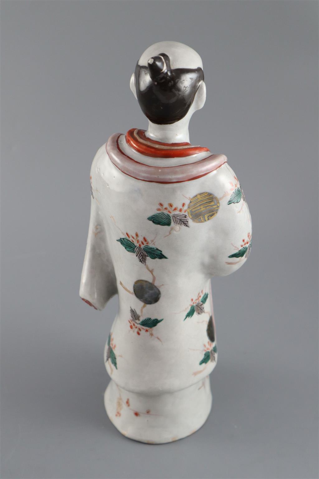 A Japanese porcelain figure of a man dressed in a kimono, Hizen, c.1690-1720, 31.5cm high